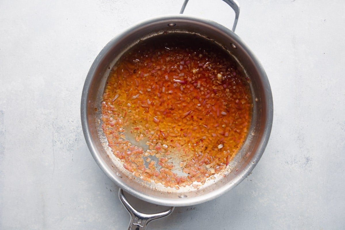 A skillet of hot bacon dressing.