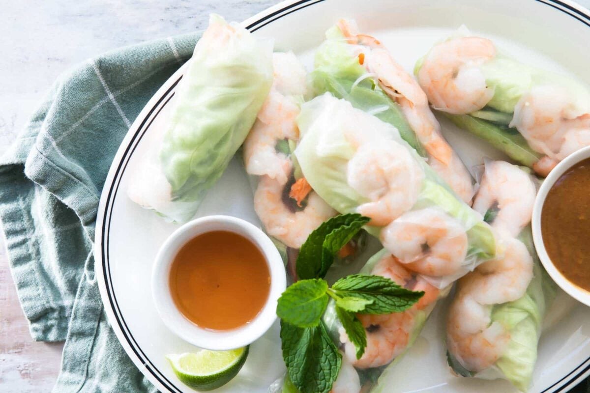 A platter of Vietnamese shrimp rolls with dipping sauces.
