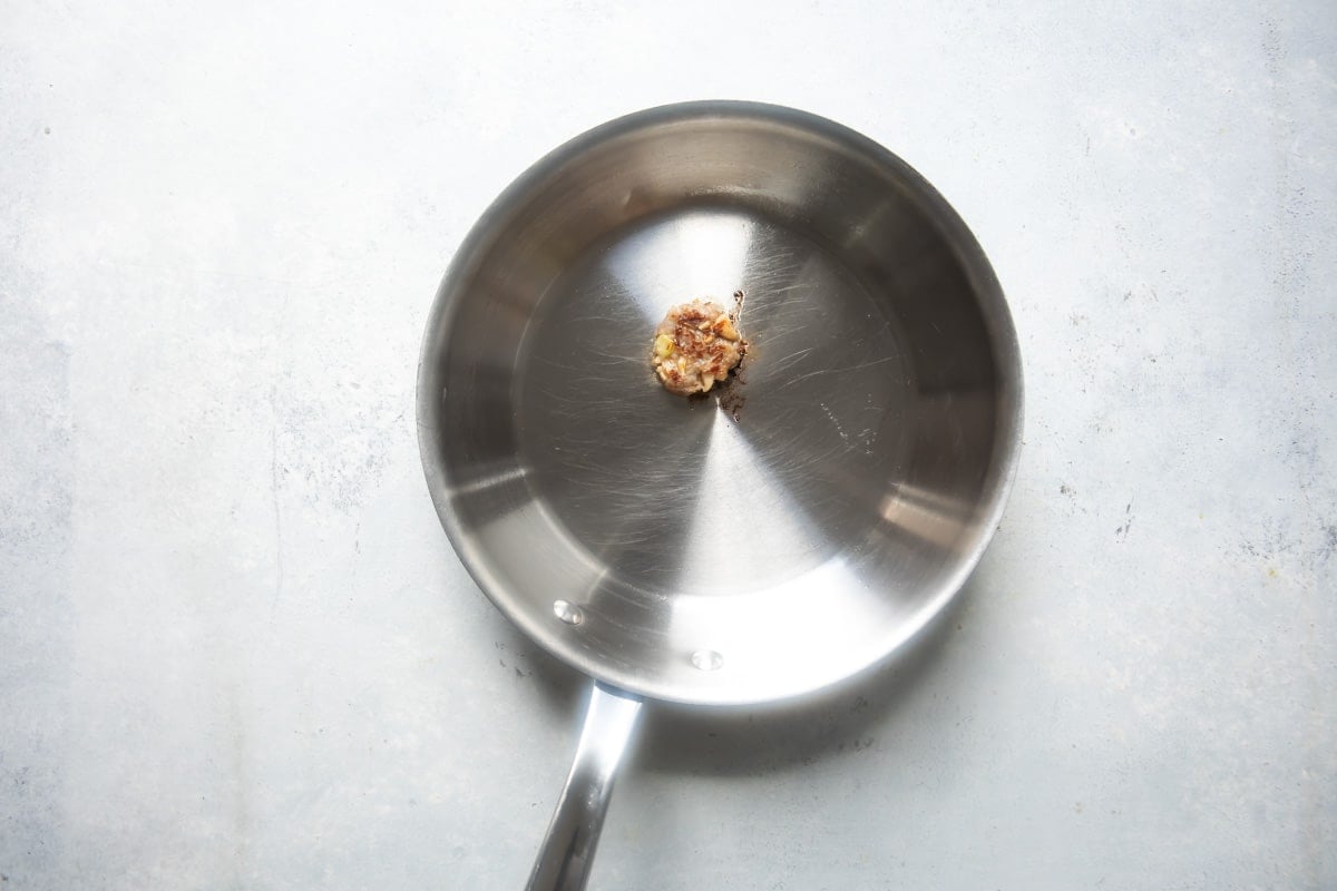 Frying a tiny patty of pork filling to taste for seasonings.