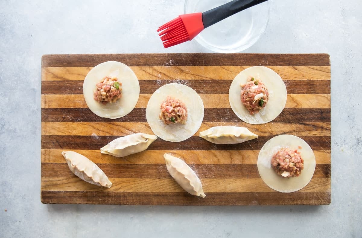Filled potstickers before cooking.