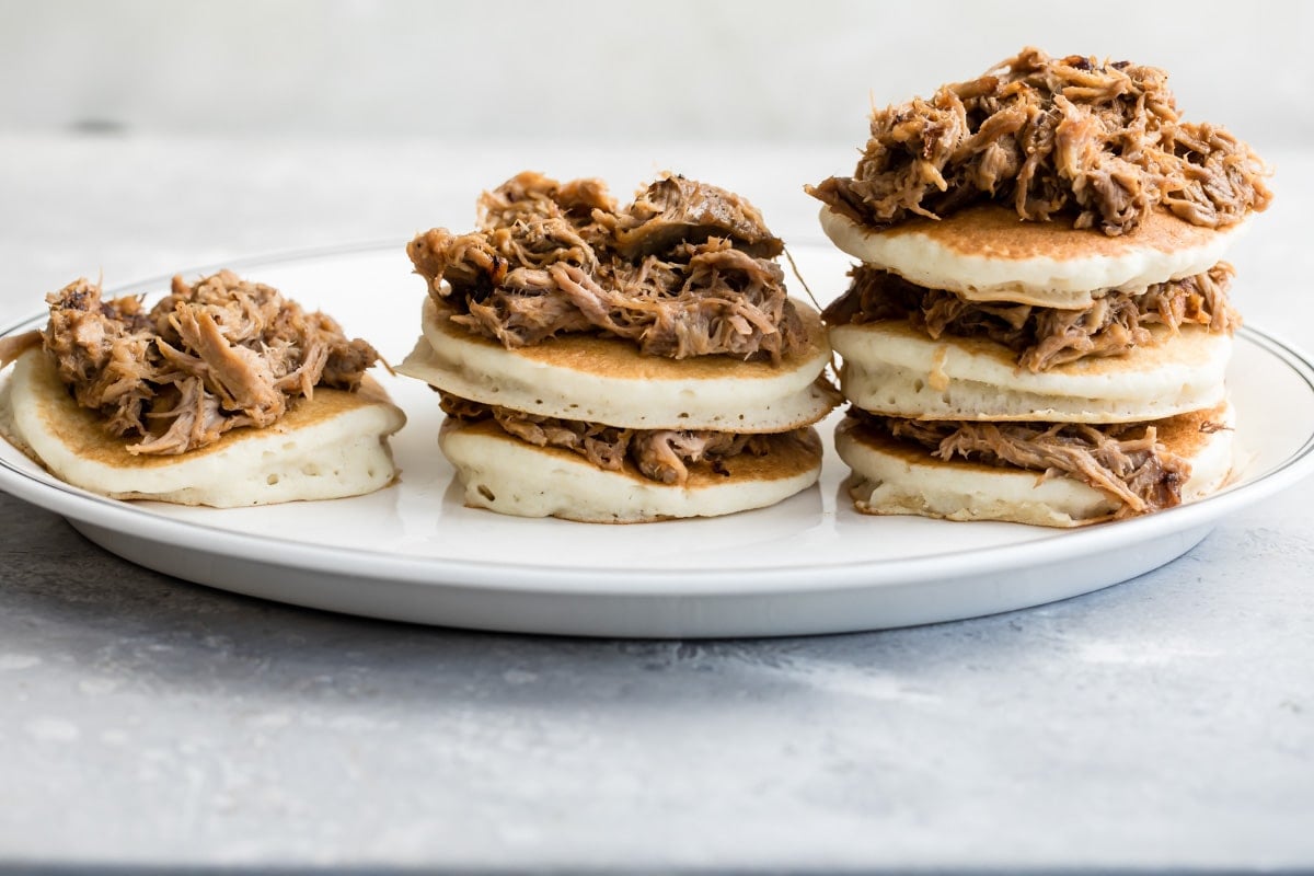 Building stacks of pulled pork pancakes.