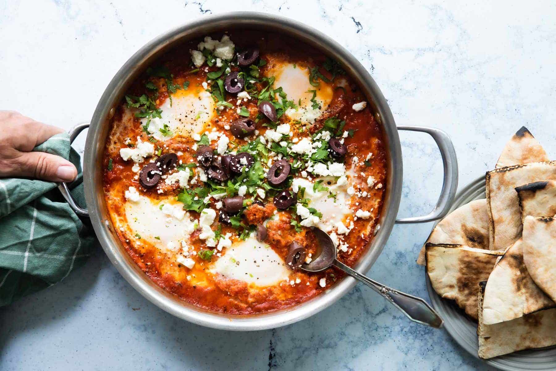 Shakshouka in a silver skillet.