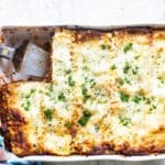 A white baking dish of lasagna.