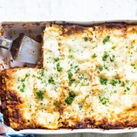 A white baking dish of lasagna.