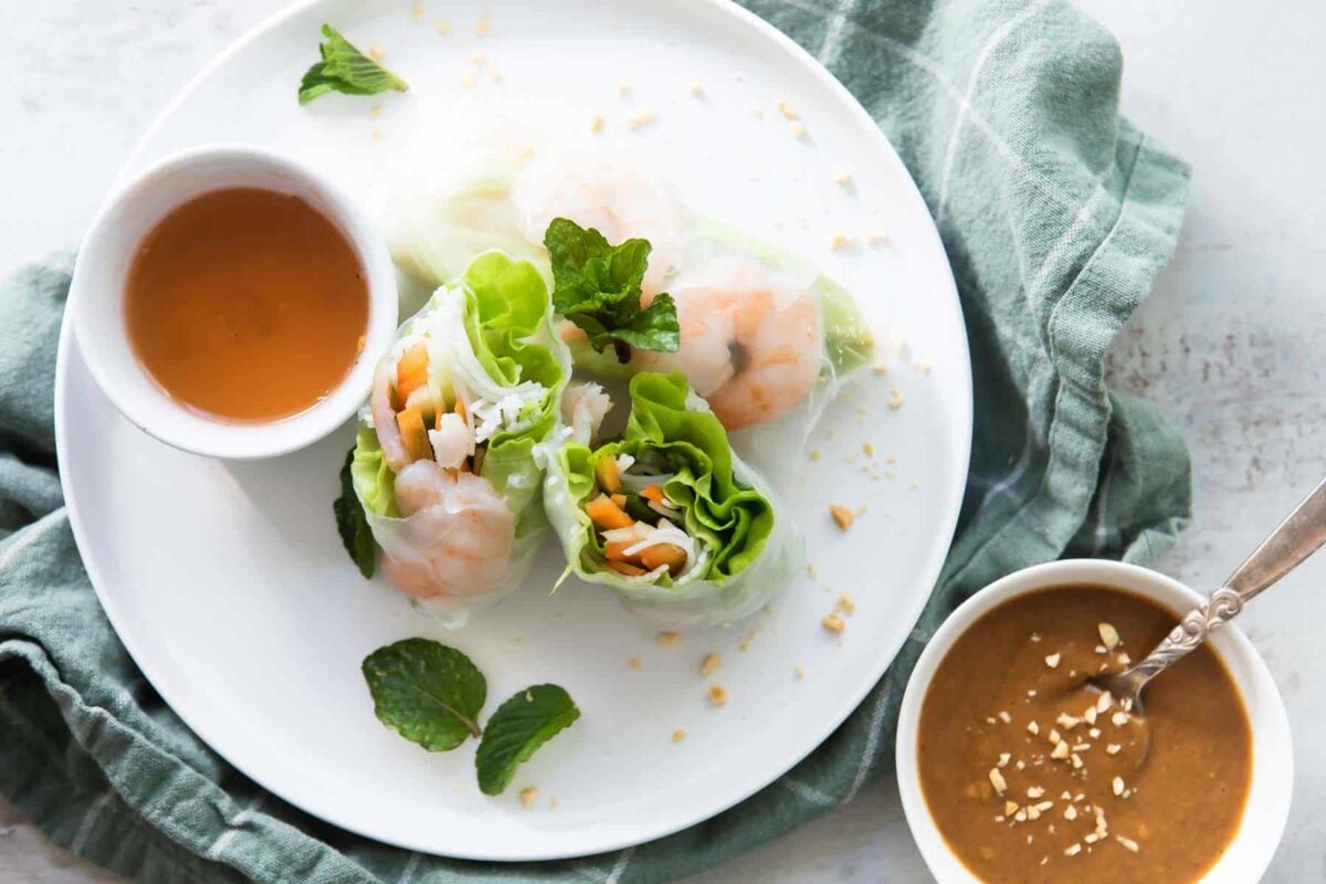A platter of Vietnamese shrimp rolls with dipping sauces.