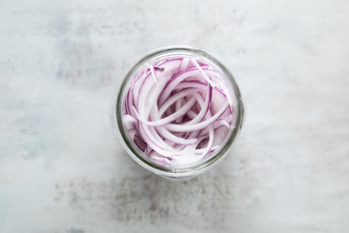 Pickled red onions in a mason jar.