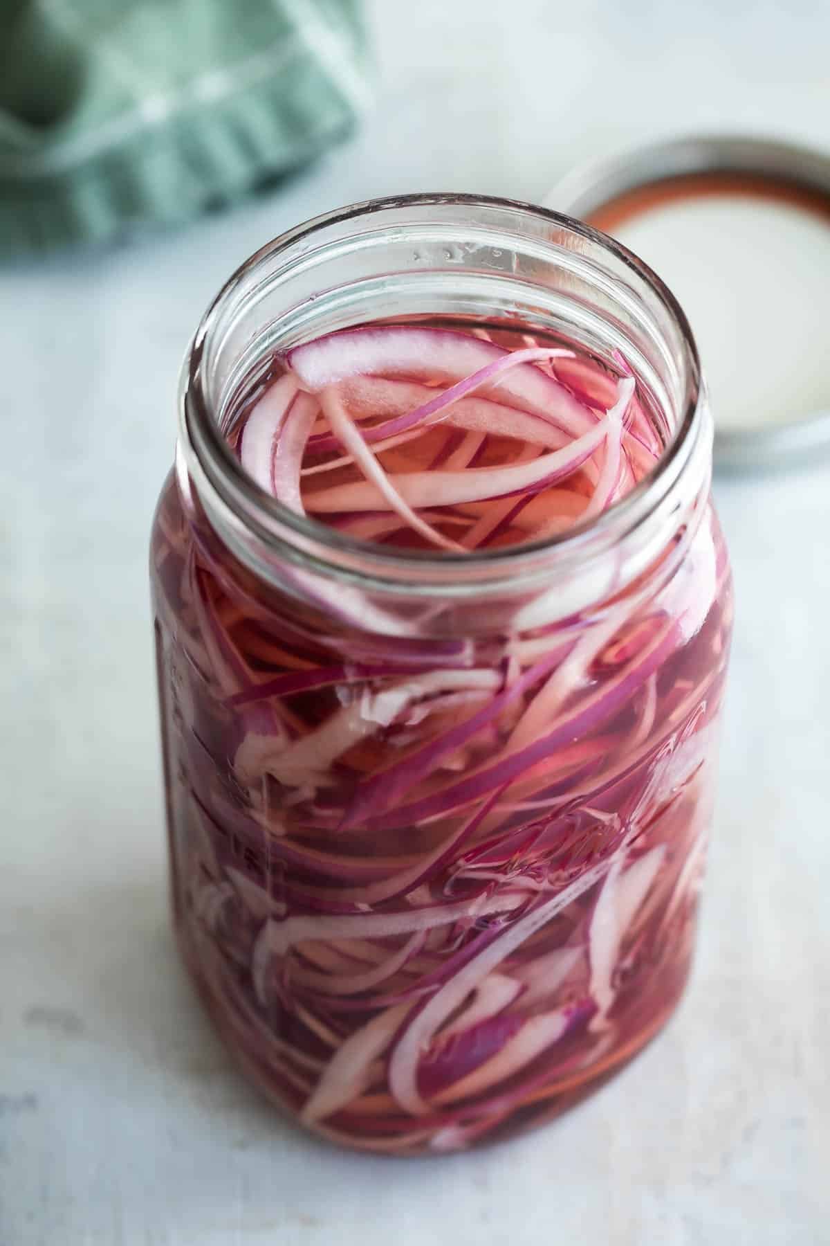 Pickled red onions in a mason jar.
