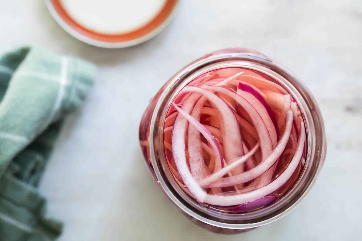 Pickled red onions in a mason jar.