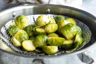 Brussels sprouts in a steamer basket.