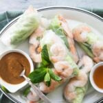 A platter of Vietnamese shrimp rolls with dipping sauces.