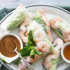 A platter of Vietnamese shrimp rolls with dipping sauces.