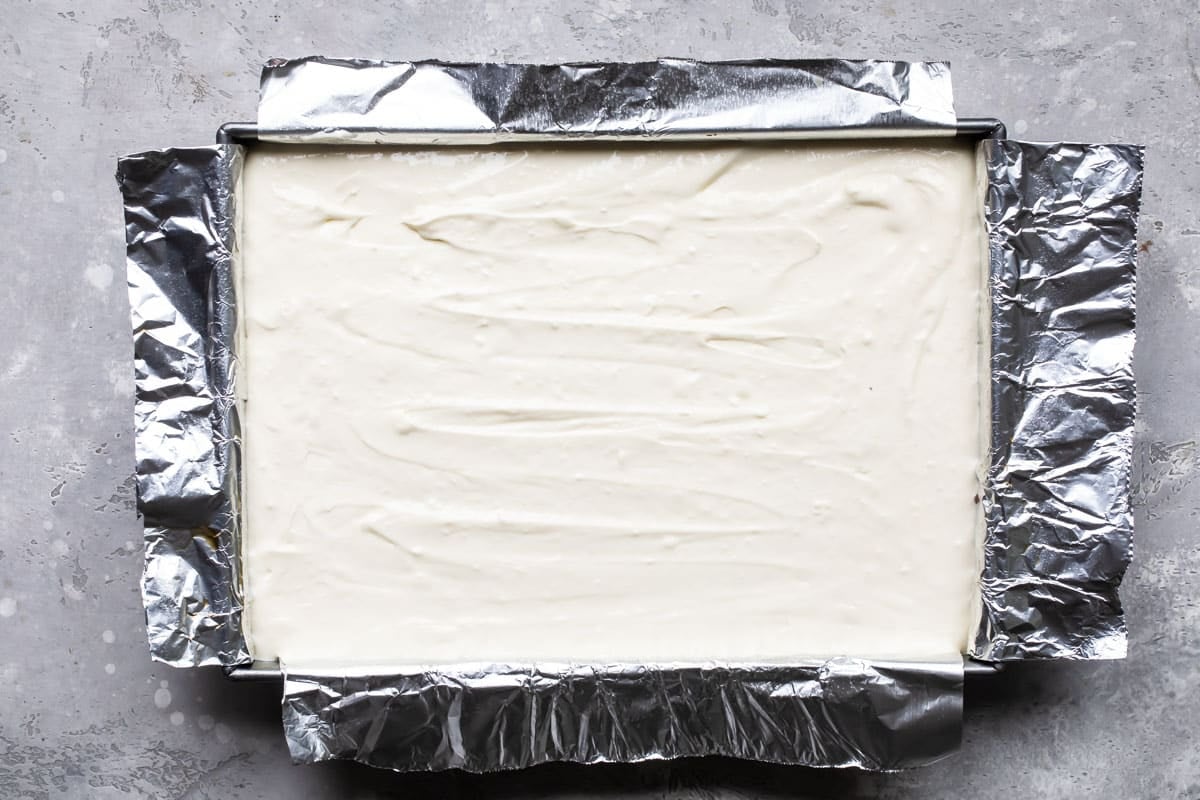 Brownies with a layer of cheesecake over them.