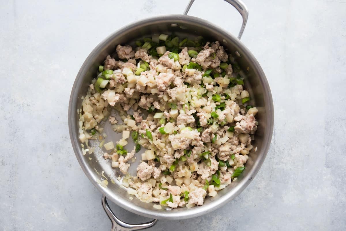 Filling for chicken lettuce wraps in a silver pan.