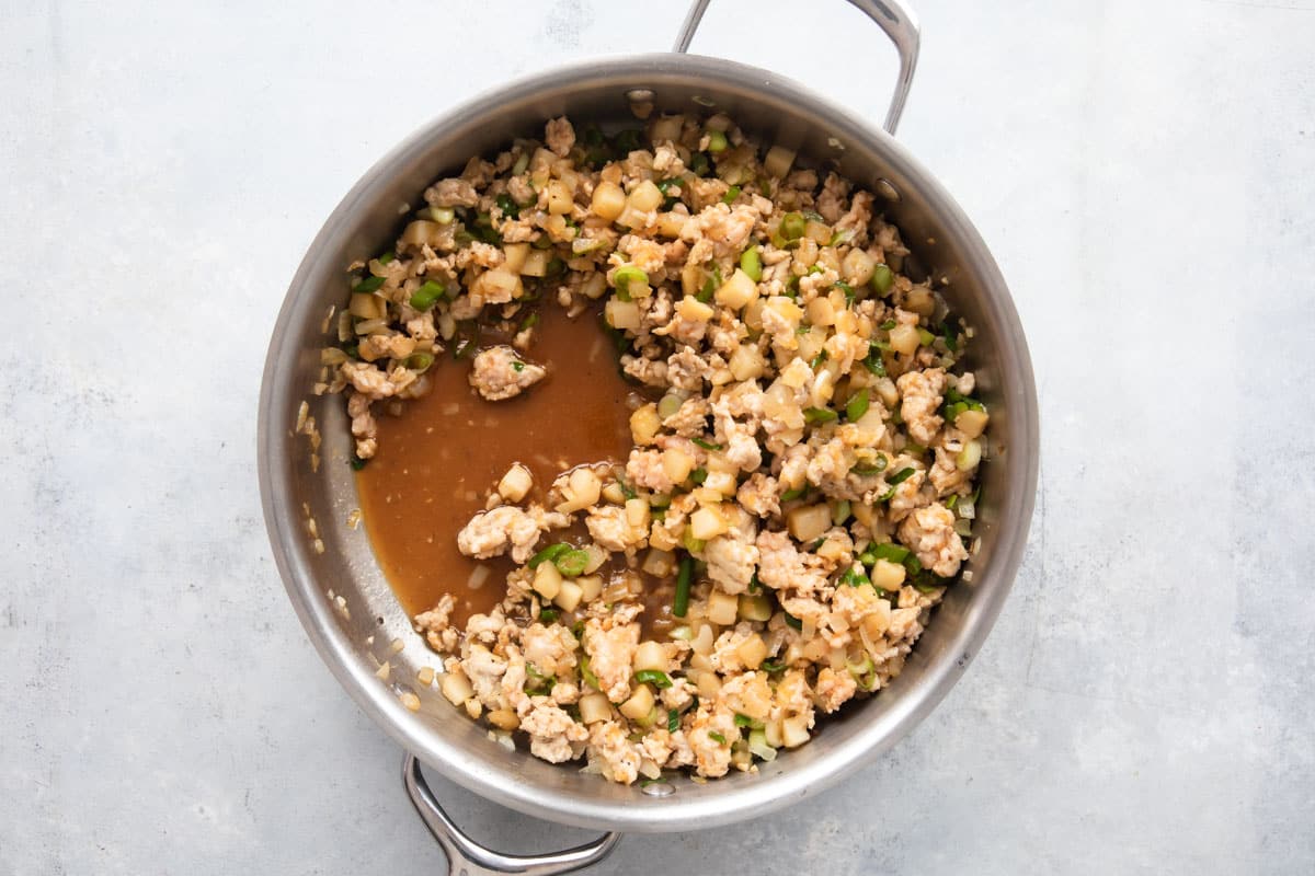 Filling for chicken lettuce wraps in a silver pan.
