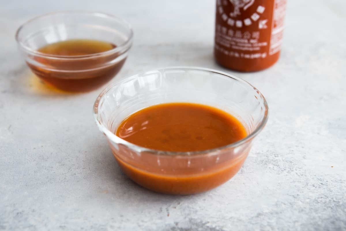 Sriracha sauce in a clear serving cup.