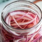Pickled red onions in a mason jar.