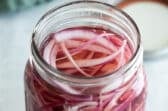 Pickled red onions in a mason jar.