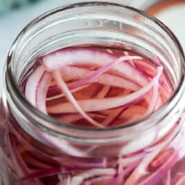 Pickled red onions in a mason jar.