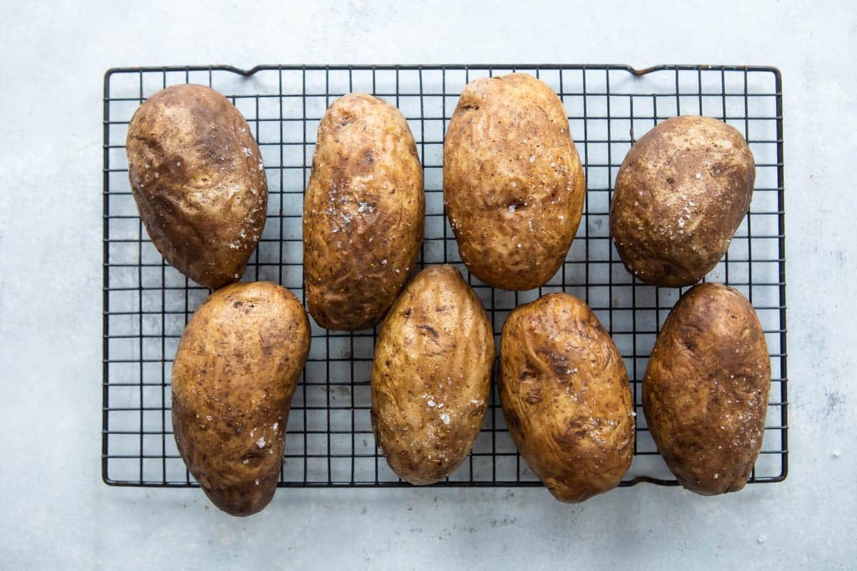 Baked potatoes on a cooling rack.