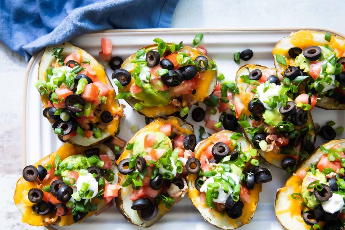 Potato skins on a rectangular serving platter.