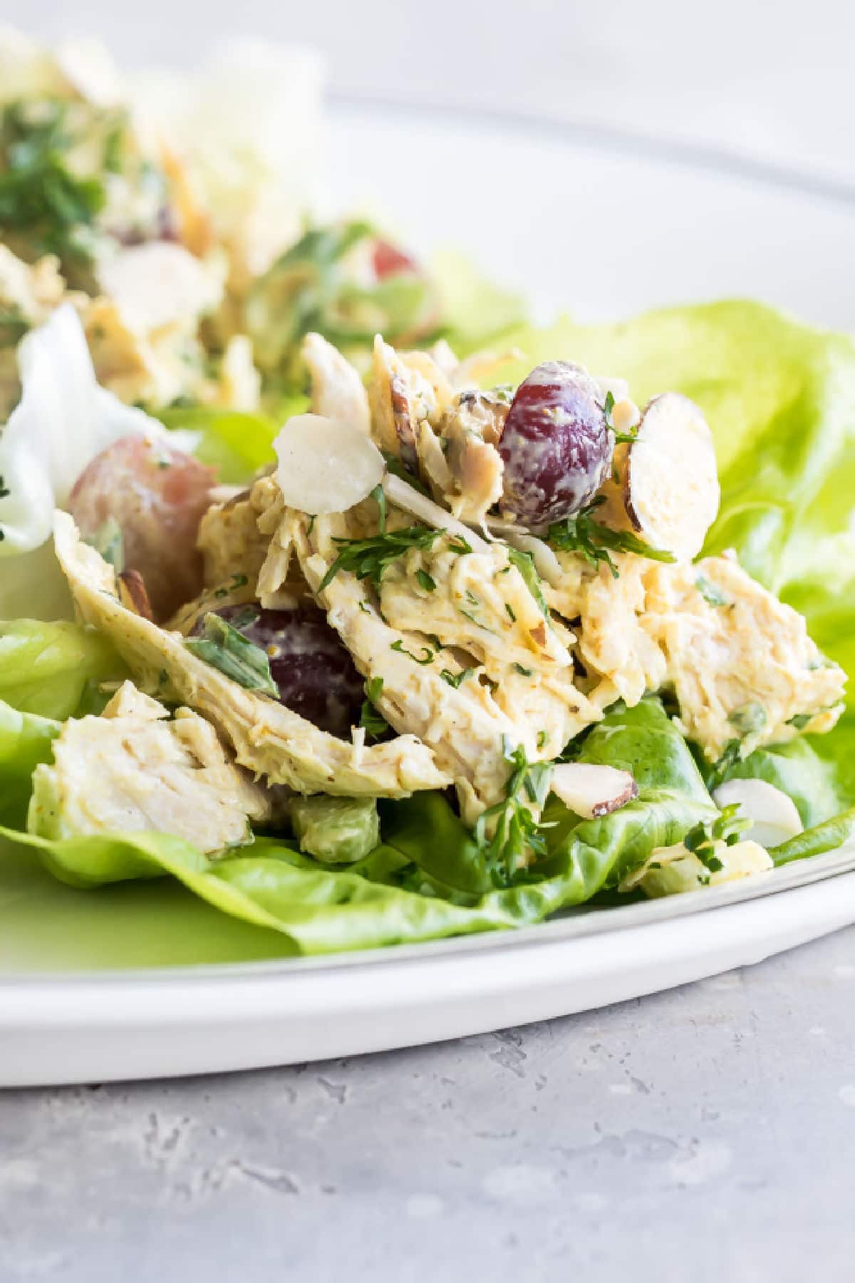 Curry chicken salad on a lettuce leaf.