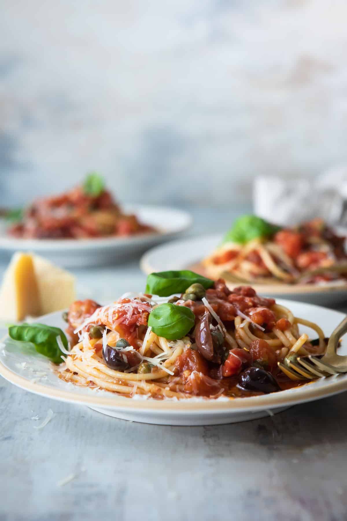 Plates of pasta puttanesca.
