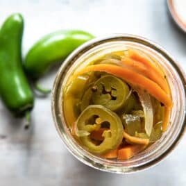A jar with pickled jalapeños.