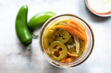 A jar with pickled jalapeños.