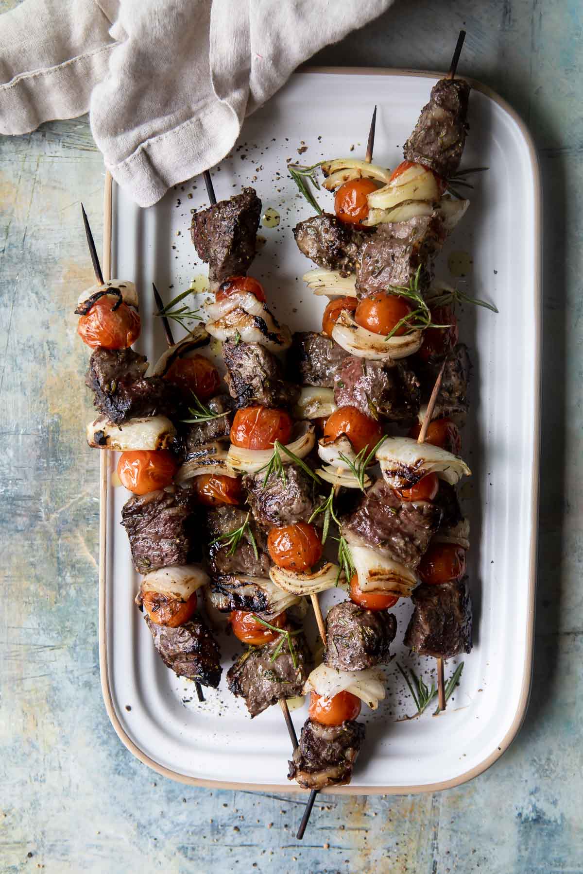 A platter full of beef kabobs.
