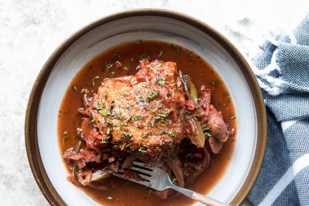 Chicken Cacciatore in white and brown bowl.
