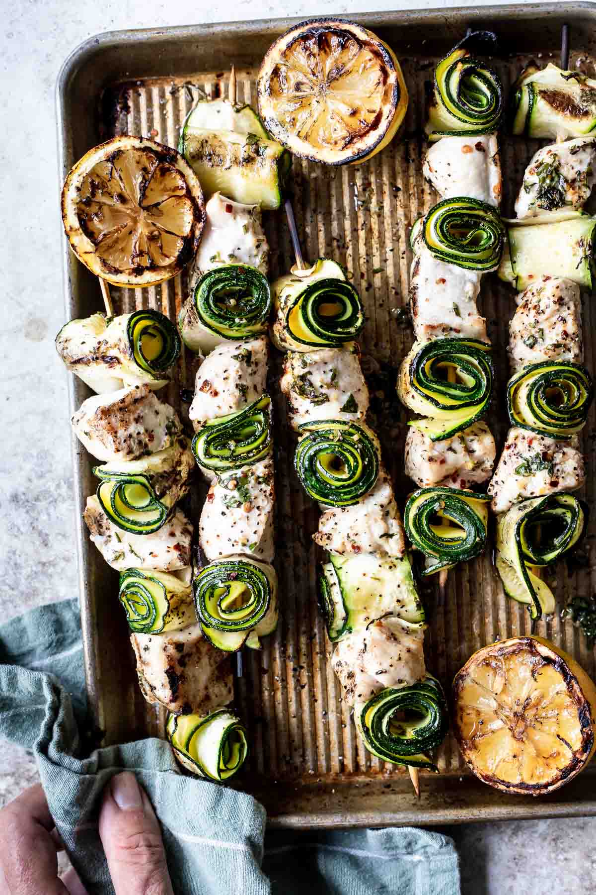 Chicken kabobs on a baking sheet.