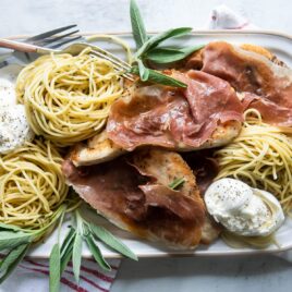 Chicken Saltimbocca on a white rectangular platter.