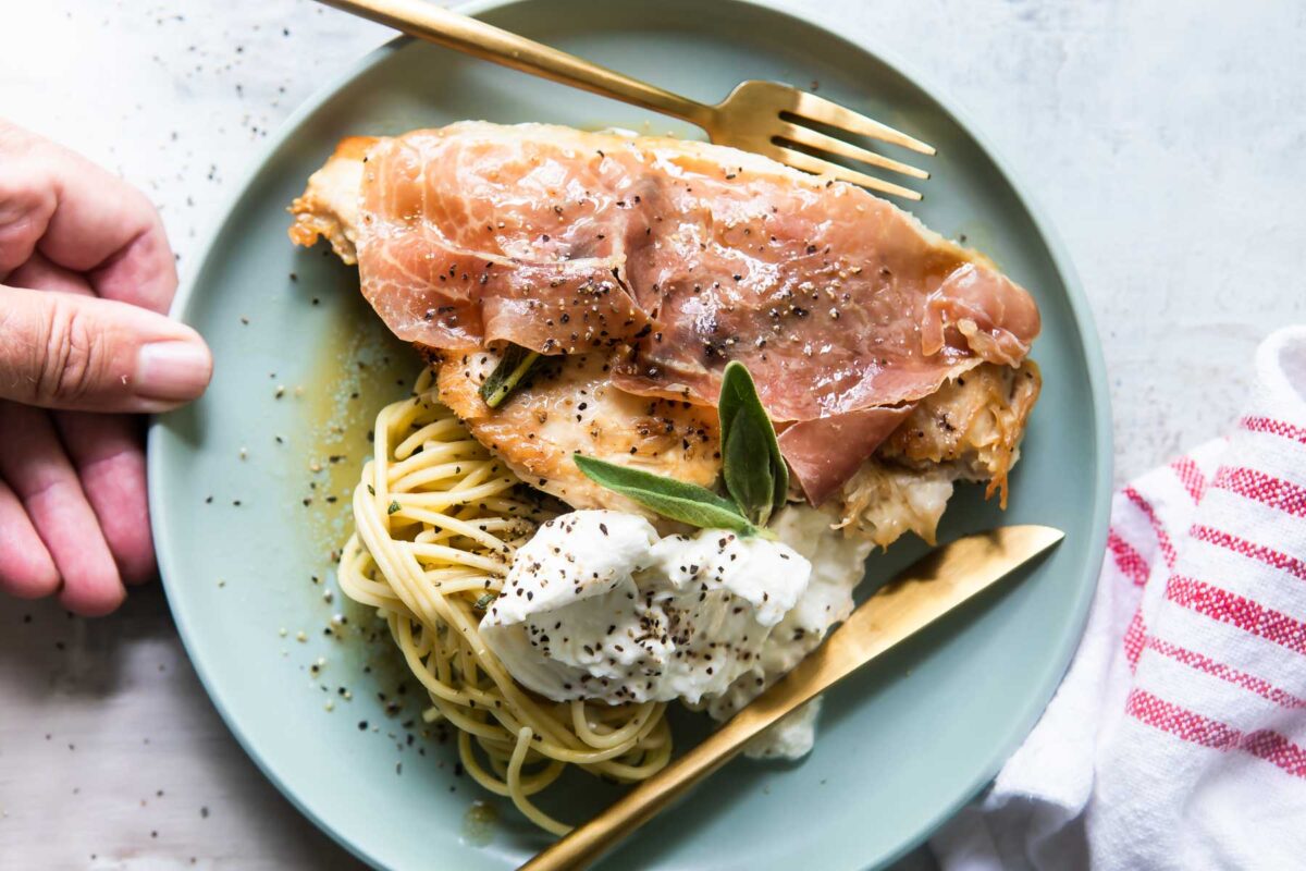 Chicken Saltimbocca on a small blue platter.