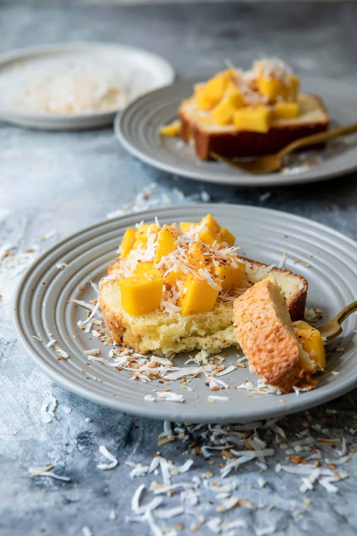 Coconut cake with mango cubes on top.