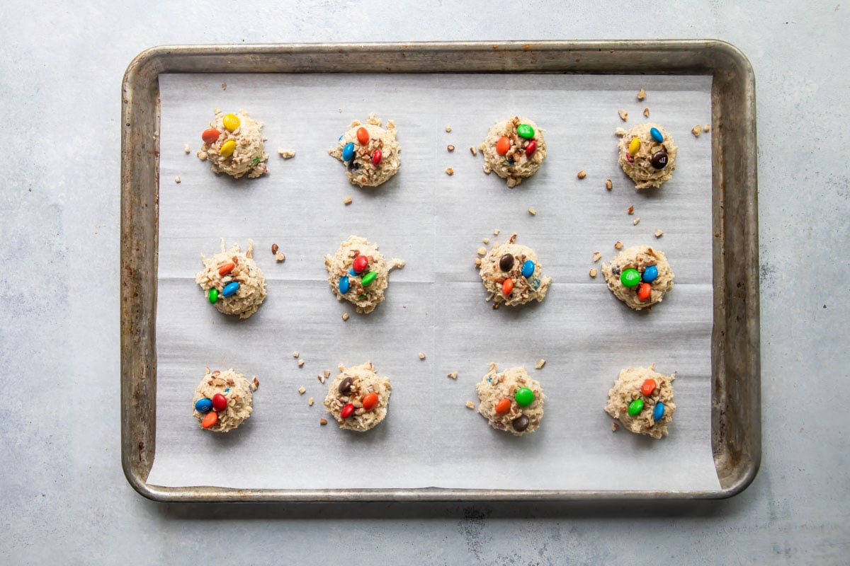Cowboy cookies on a cookie sheet before being baked.
