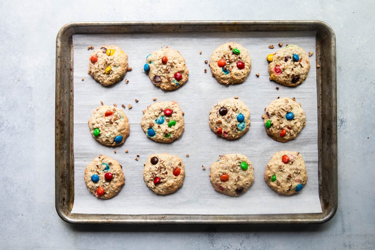 Cowboy cookies on a cookie sheet after coming out of the oven.