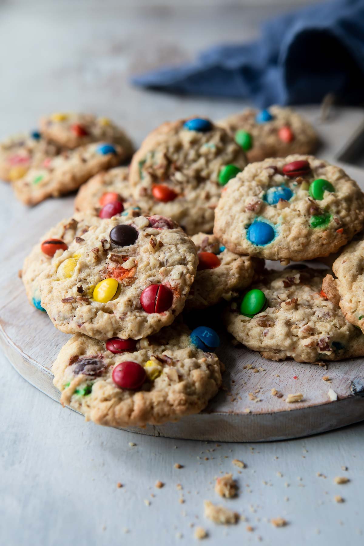 Cowboy cookies on a circular wooden platter.
