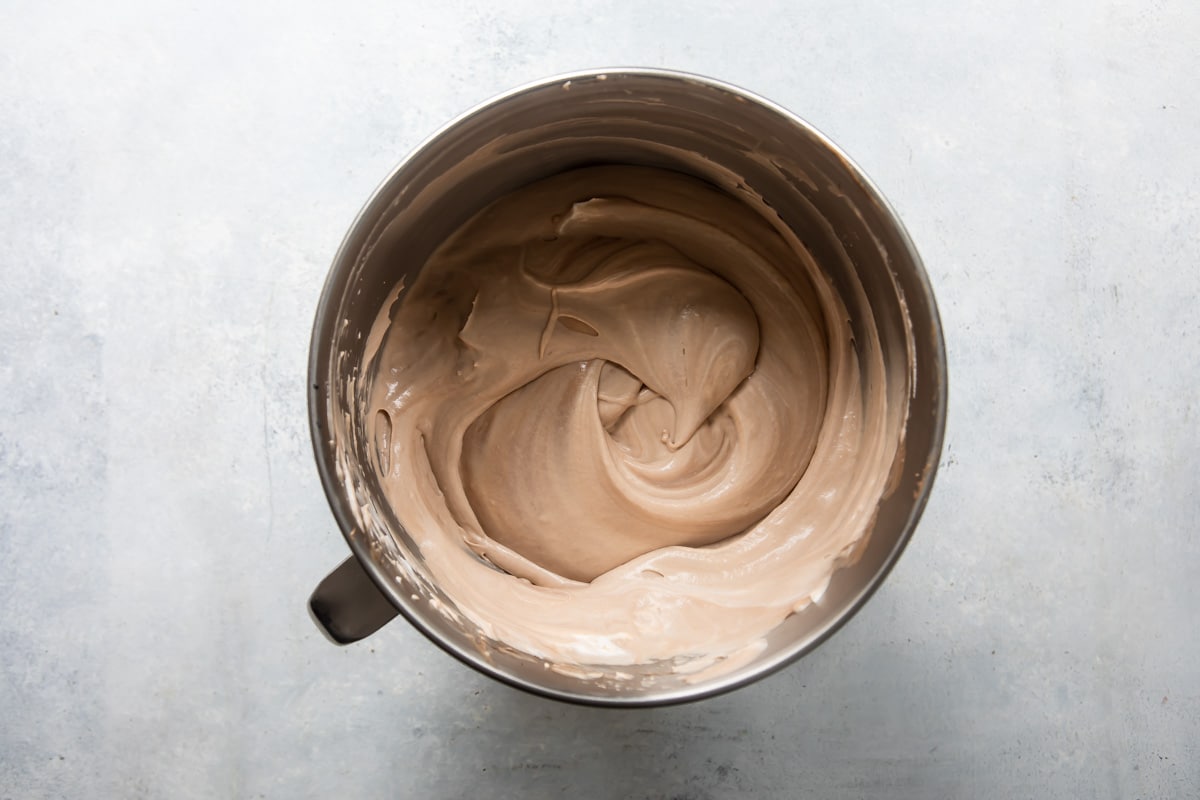 Chocolate frosty cheesecake mixture in a mixing bowl.