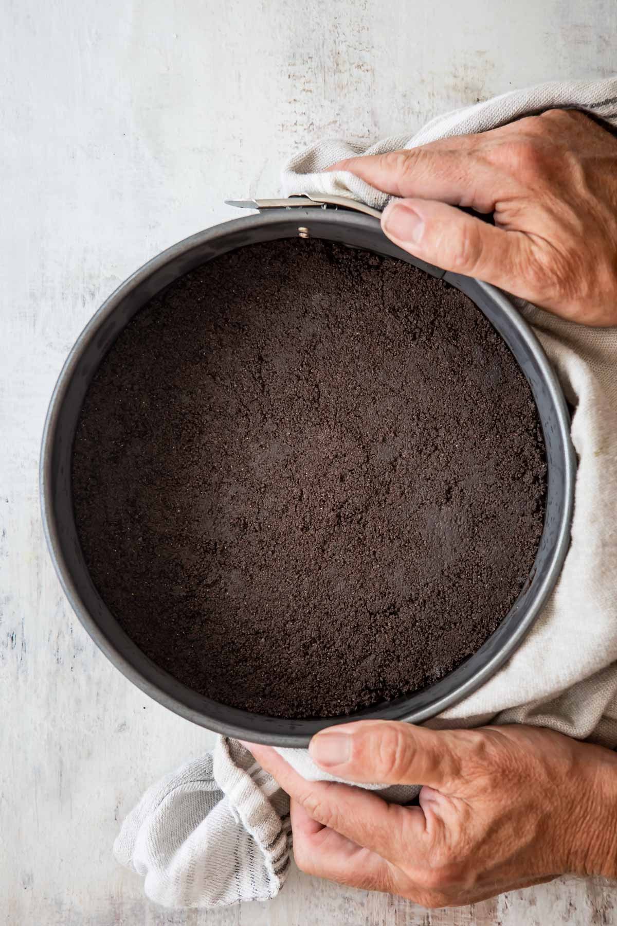 Someone holding an oreo cookie crust.