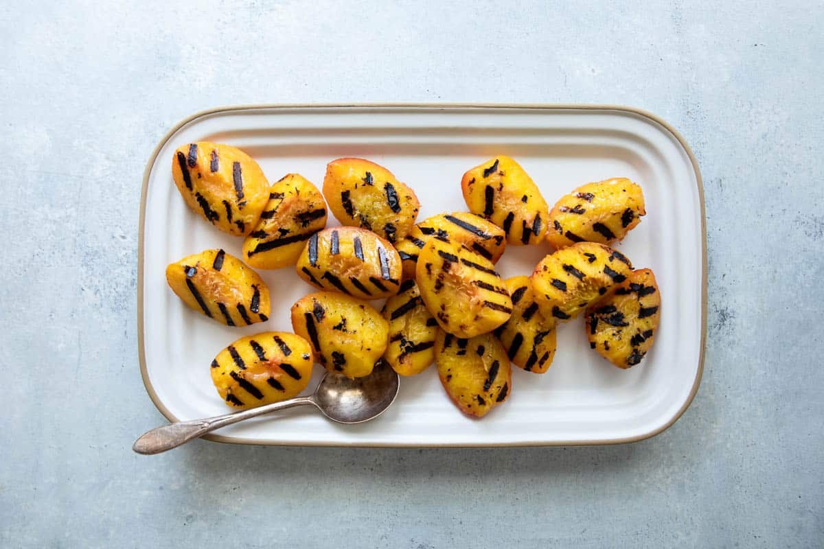 A platter of grilled peaches.