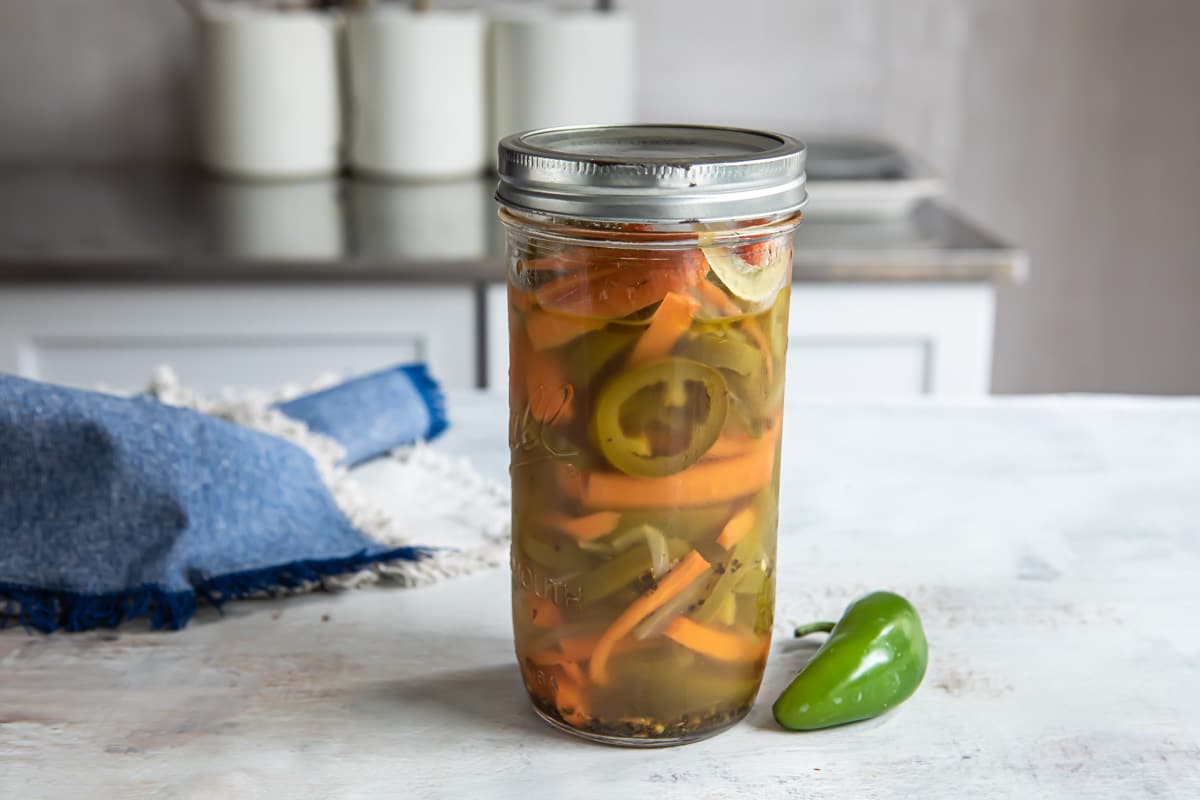 A jar with pickled jalapeños.