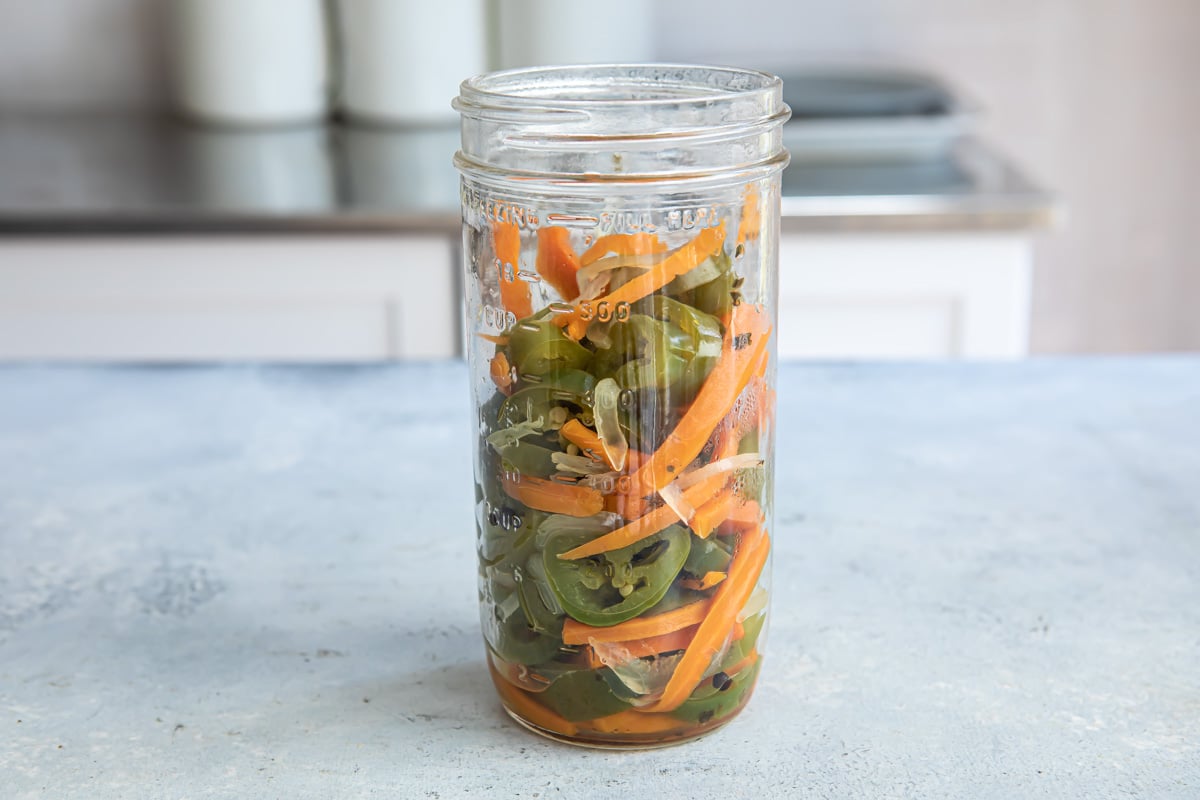 A jar of drained pickled jalapeños.