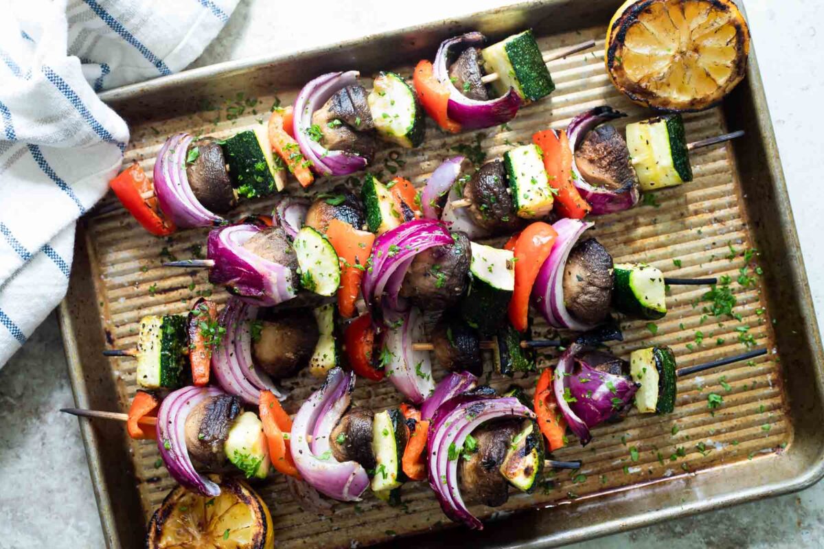 Veggie kabobs on a baking sheet.