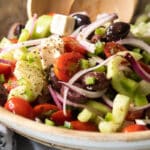 A Greek salad in a wooden bowl.