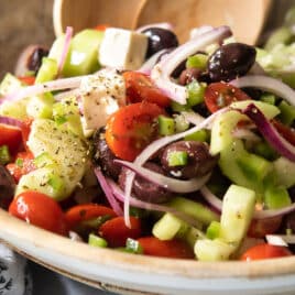 A Greek salad in a wooden bowl.