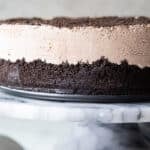 Frosty cheesecake on a marble serving platter.