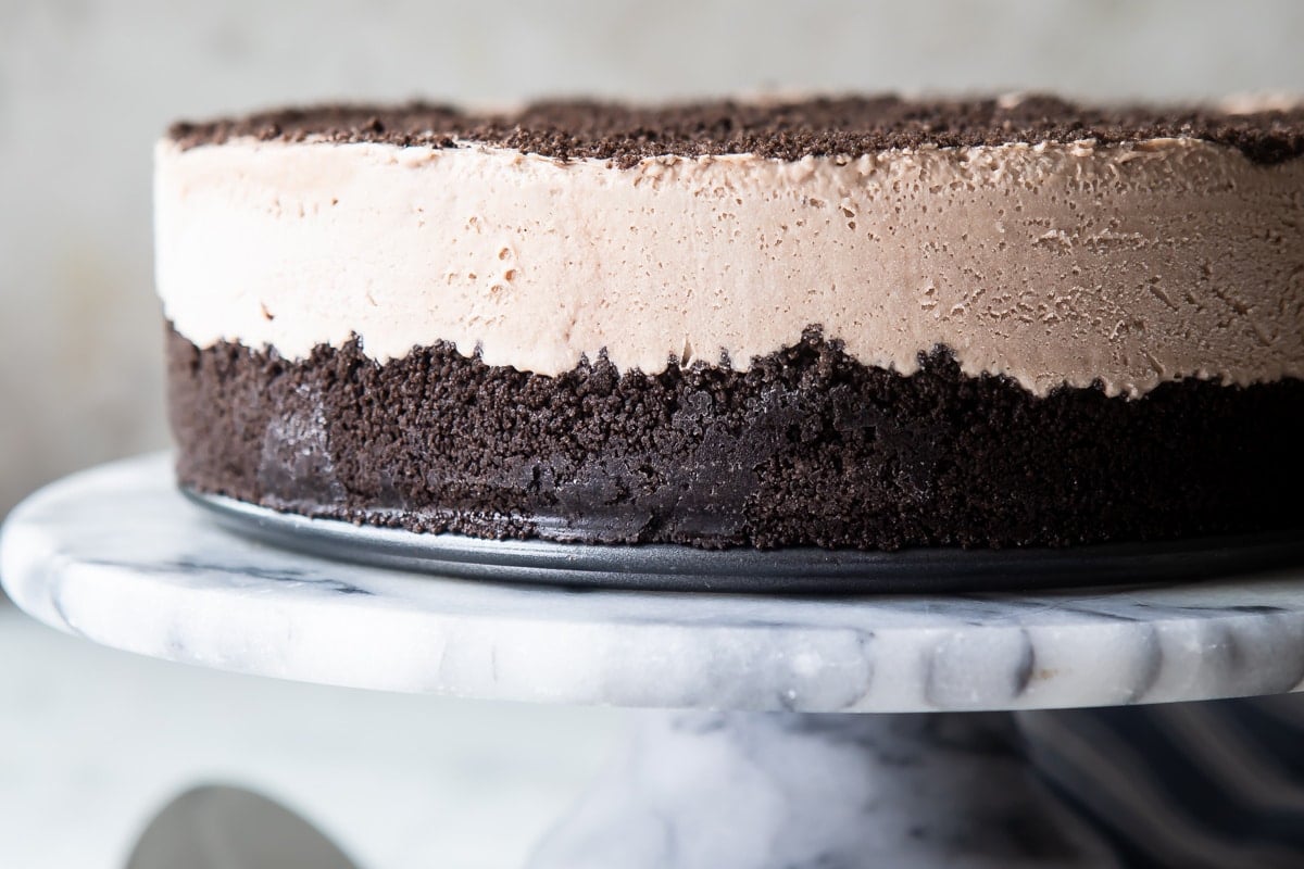 Frosty cheesecake on a marble serving platter.