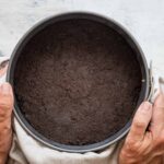 Someone holding an oreo cookie crust.