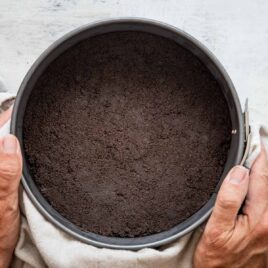 Someone holding an oreo cookie crust.