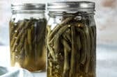 Two jars of pickled green beans.